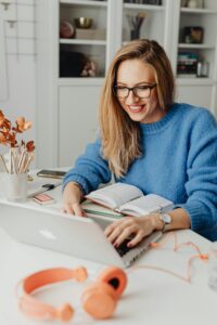 A happy student working on her laptop