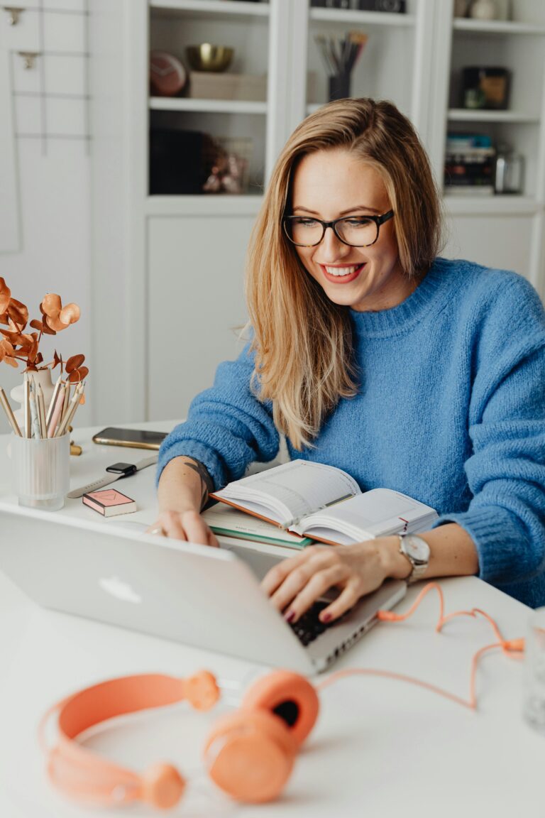 A happy student working on her laptop